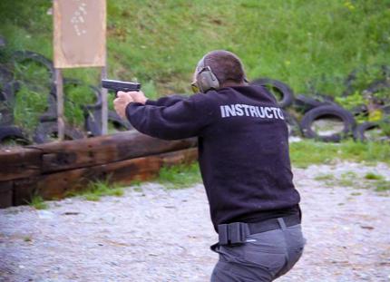 Instructor demonstrates dynamic pistol shooting at training ground in Bulgaria