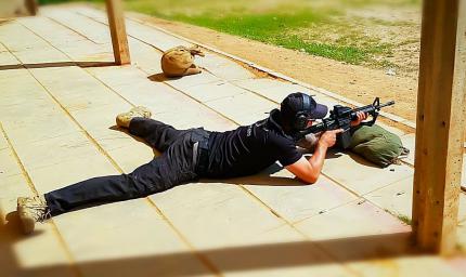A cadet of the FEDERAL PERFORMANCE SERVICE in a lying position fires with an M16 assault rifle at the training ground in Israel